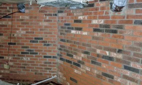 Brick walls in the full basement. 