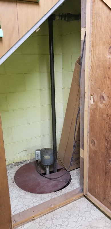 Sump Pump Hidden Under The Downstairs Staircase