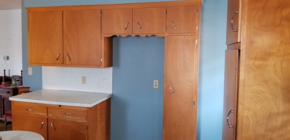 Refrigerator Space Surround Kitchen Cabinets & Counter Top