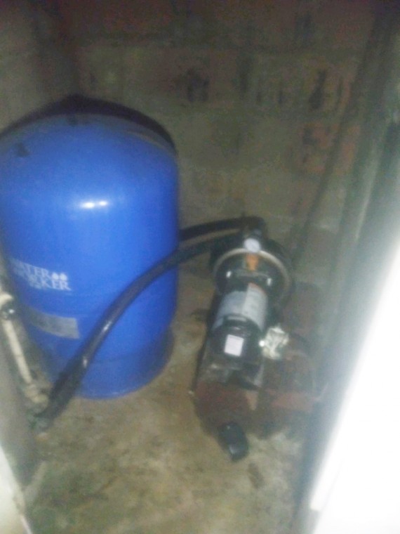 Private well water pump and storage tank.