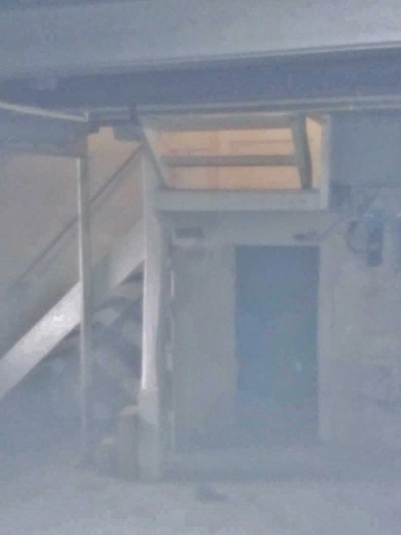 The basement stairway leading to the upstairs kitchen landing.