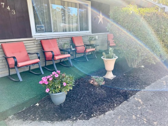 Nice large covered front porch with afternoon sun rays.