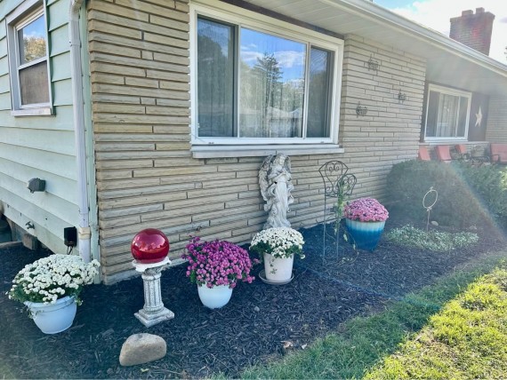 Stone Brick Facade. Nice Colorful Front Yard Landscaping