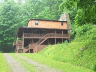 PUBLIC AUCTION OF REAL ESTATE - UNIQUE ROCK WALL LOG CABIN