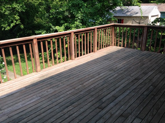 Large deck overlooking large, fenced back yard